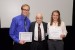 Dr. Nagib Callaos, General Chair, giving Mr. Zachary Balgeman and Ms. Chelsey Bradford the best paper award certificate of the session "Education and Information Systems, Technologies and Applications III." The title of the awarded paper is "A Multidisciplinary Course for Developing, Nurturing, and Strengthening Student Creativity."